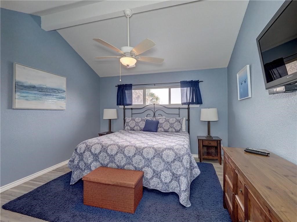 715 Beach Access Road, Unit 1204 Port Aransas, TX 78373 - Photo 15 of 33 a bedroom with a bed and a tv on table