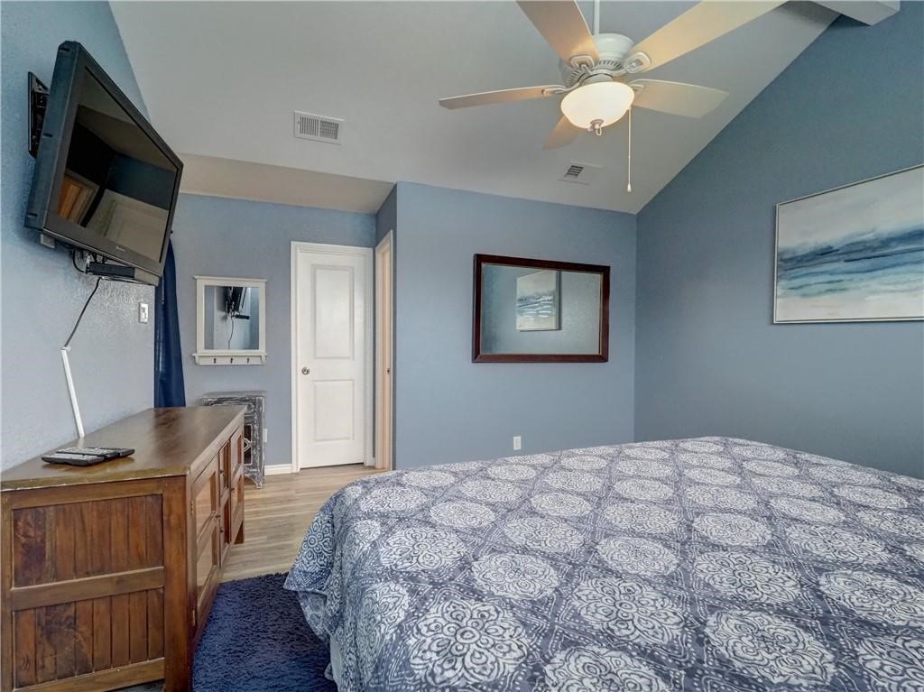 715 Beach Access Road, Unit 1204 Port Aransas, TX 78373 - Photo 16 of 33 a bedroom with a bed and a flat tv screen on dresser