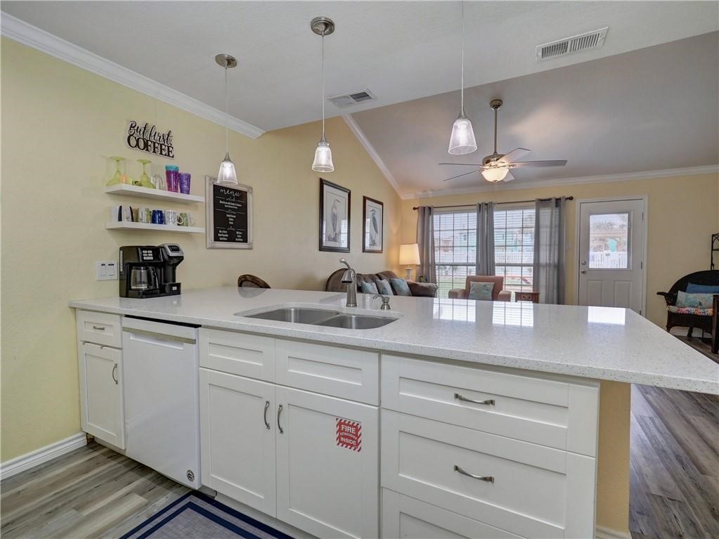 715 Beach Access Road, Unit 1204 Port Aransas, TX 78373 - Photo 3 of 33 a kitchen with cabinets appliances and a counter top space