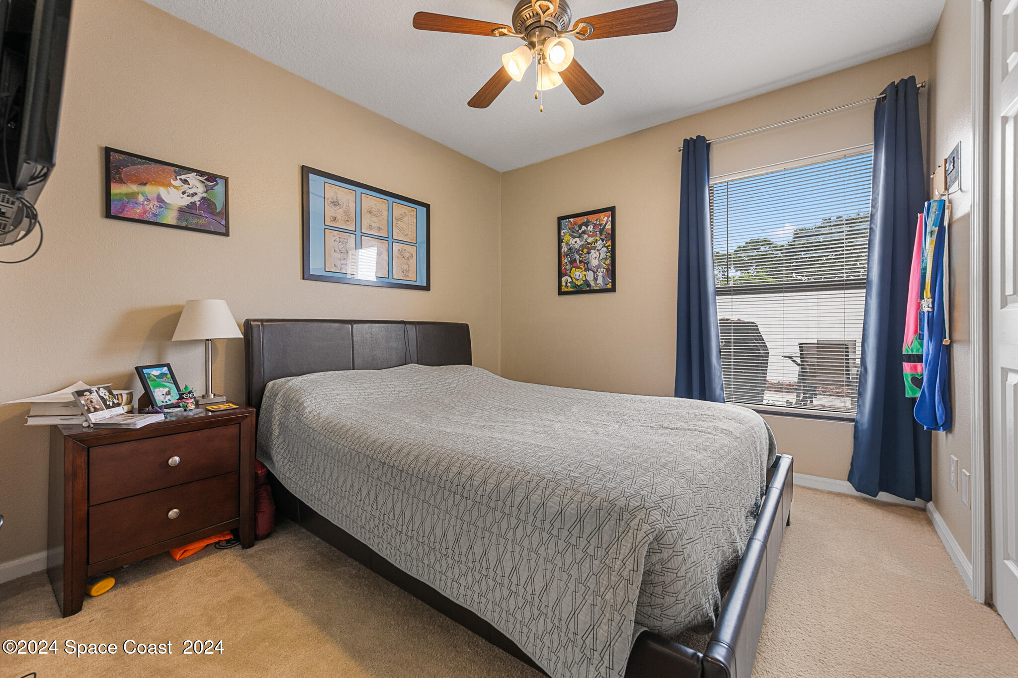 890 Luminary Circle, Unit 103 Melbourne, FL 32901 - Photo 13 of 32 a bedroom with a bed and a chandelier
