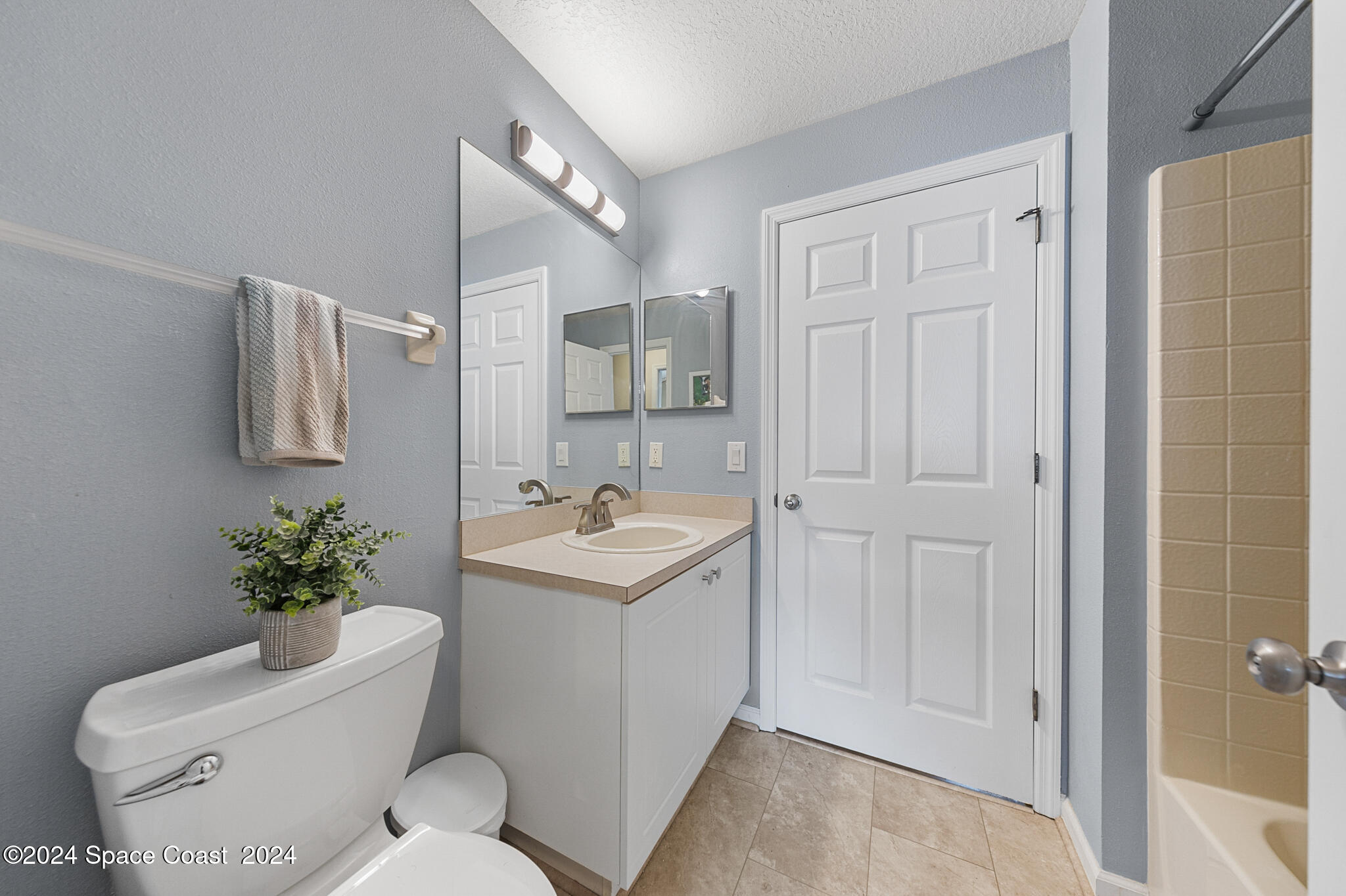 890 Luminary Circle, Unit 103 Melbourne, FL 32901 - Photo 14 of 32 a bathroom with a sink toilet and shower
