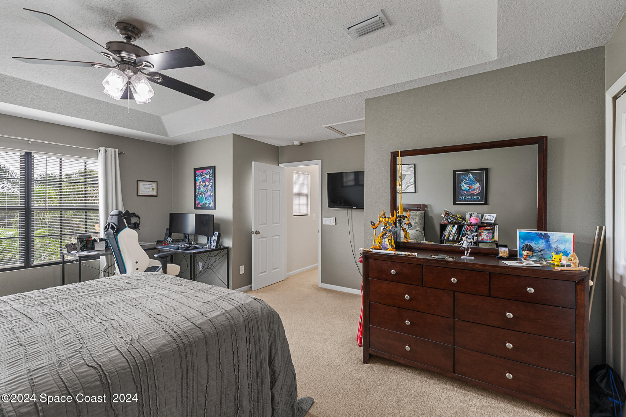 890 Luminary Circle, Unit 103 Melbourne, FL 32901 - Photo 17 of 32 a bedroom with a bed and a dresser in it