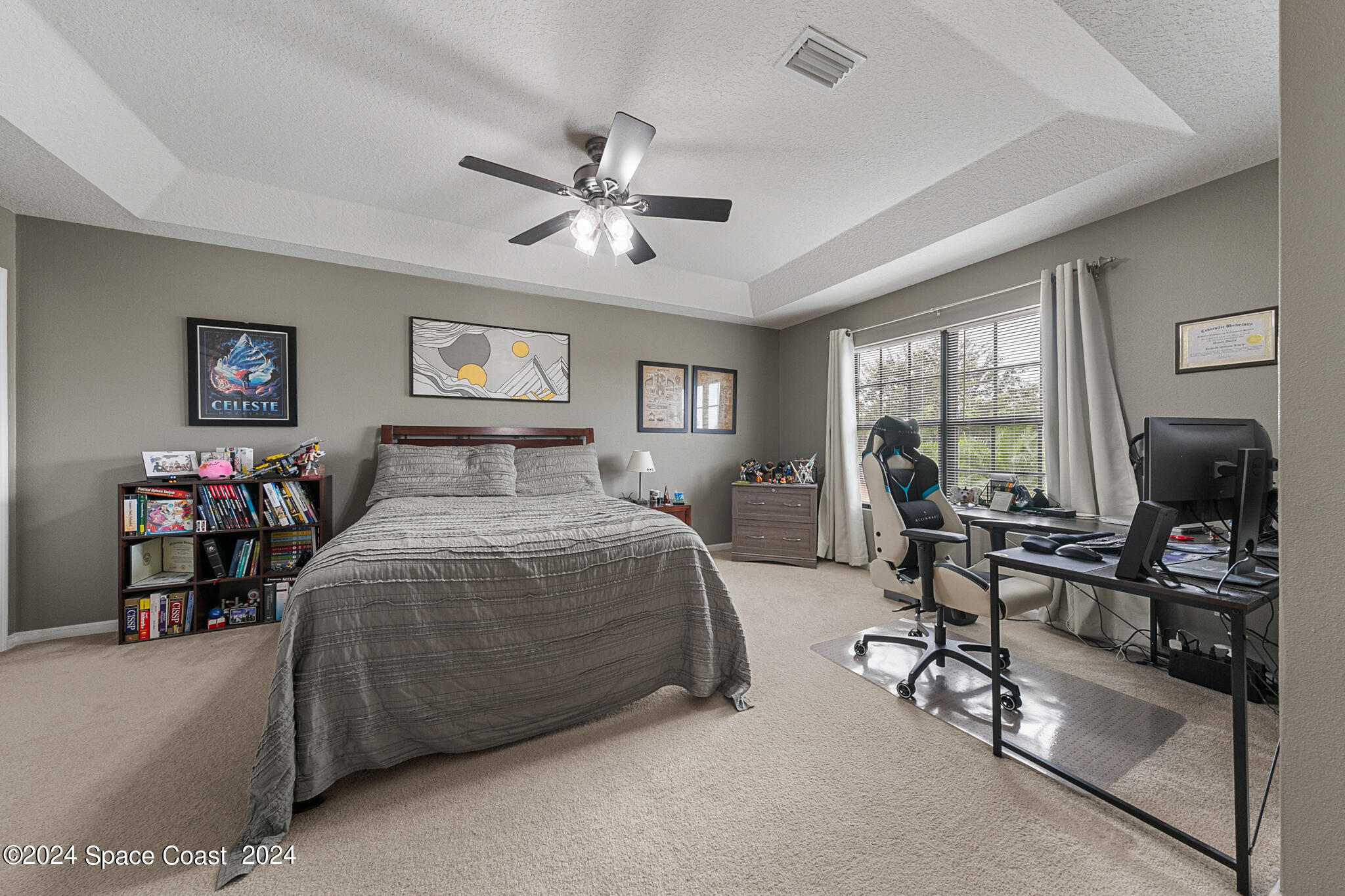 890 Luminary Circle, Unit 103 Melbourne, FL 32901 - Photo 19 of 32 a bedroom with a bed and wooden floor