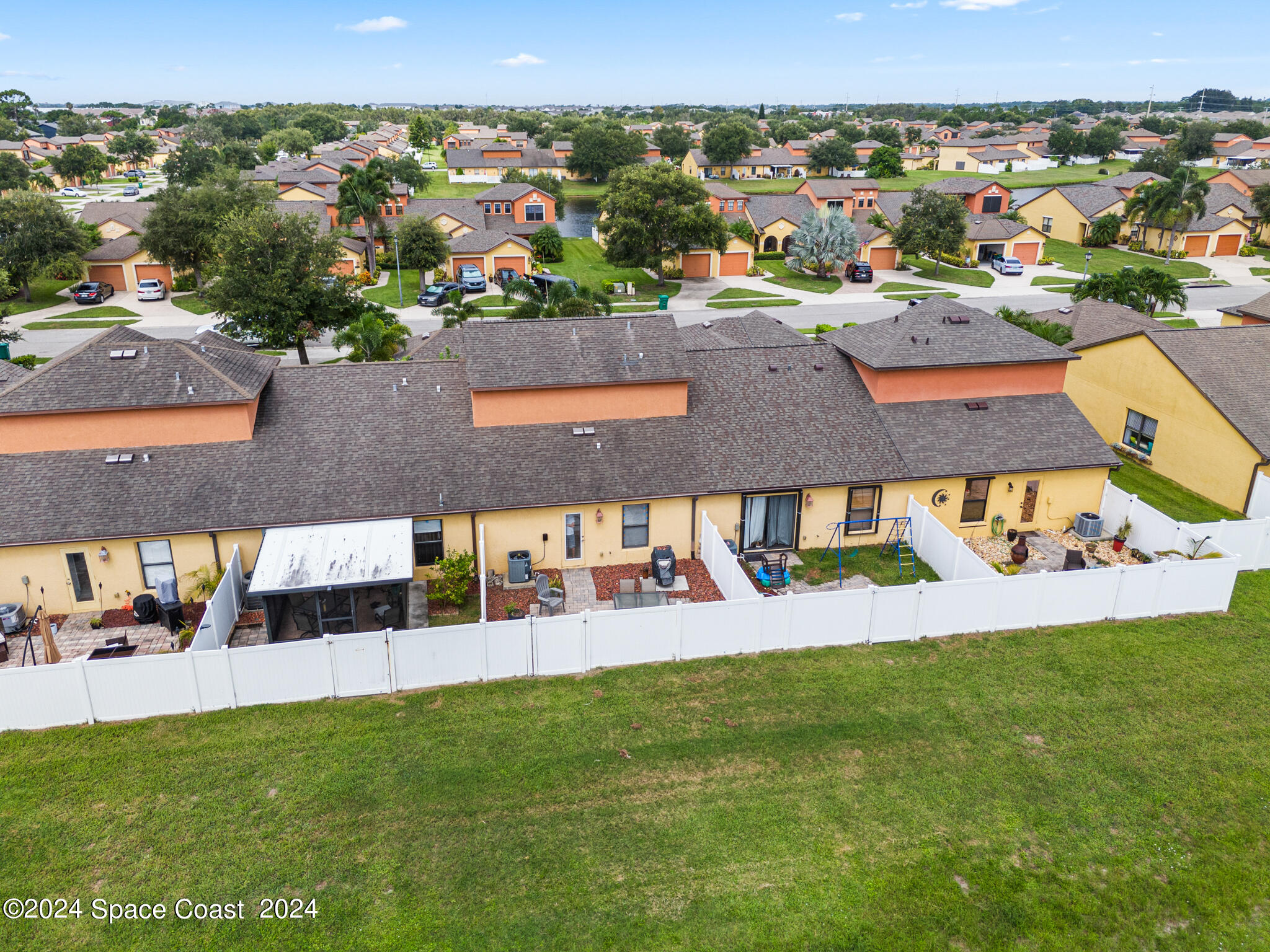 890 Luminary Circle, Unit 103 Melbourne, FL 32901 - Photo 27 of 32 an aerial view of residential houses with outdoor space and trees