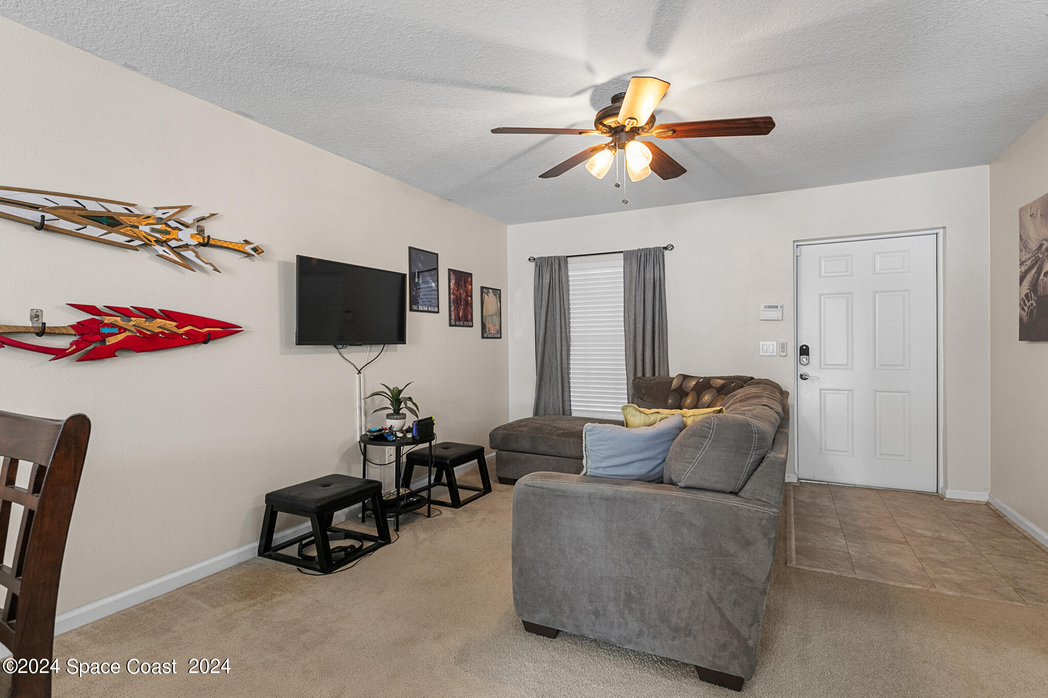 890 Luminary Circle, Unit 103 Melbourne, FL 32901 - Photo 7 of 32 a living room with furniture and a flat screen tv