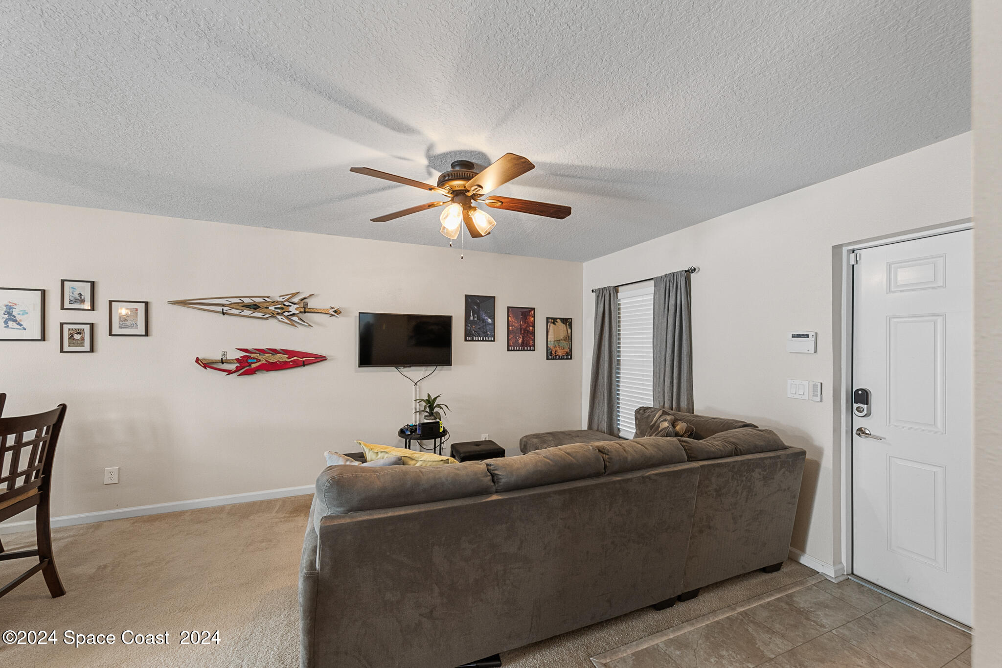 890 Luminary Circle, Unit 103 Melbourne, FL 32901 - Photo 8 of 32 a living room with furniture and a ceiling fan