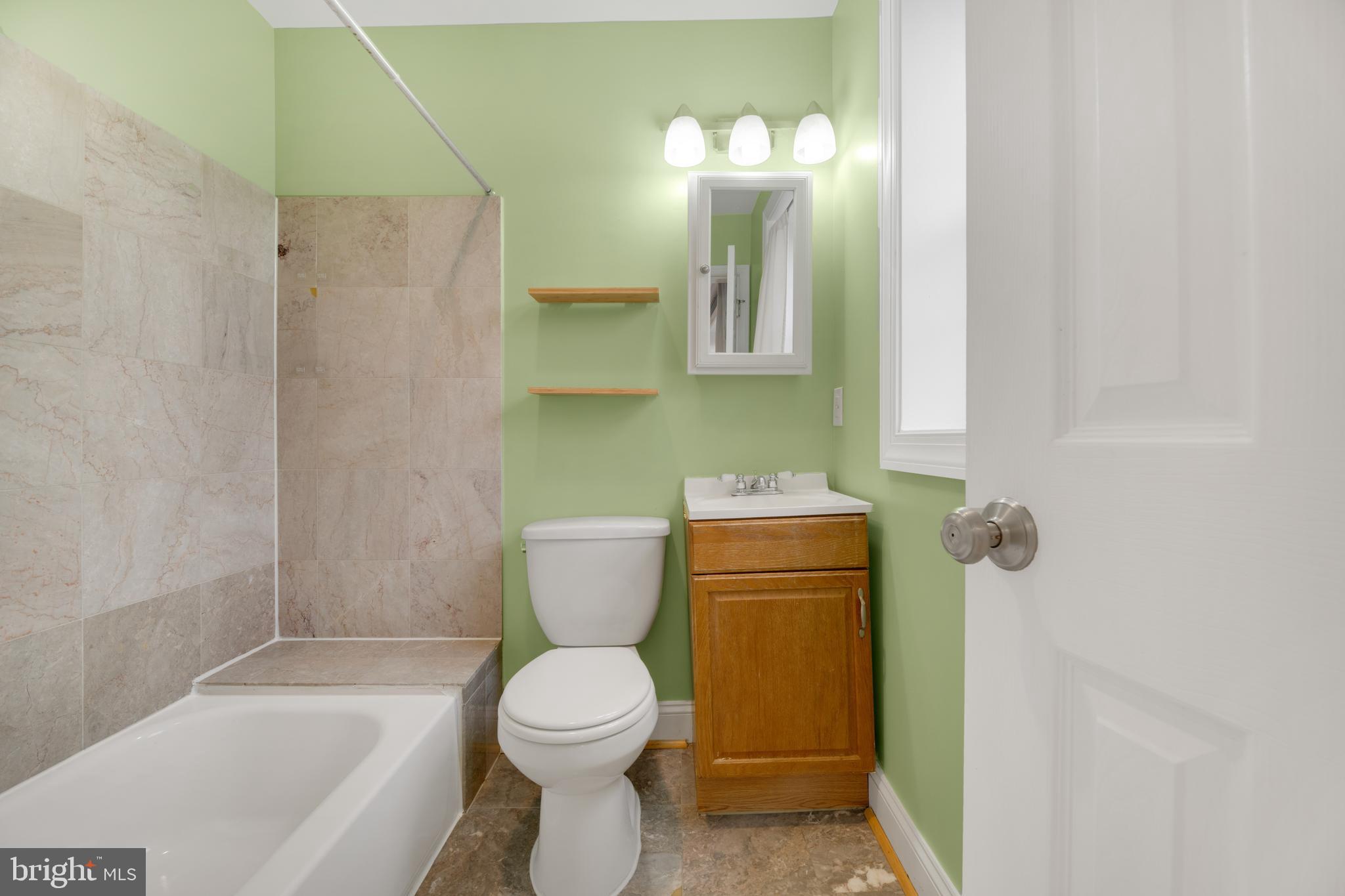 1917 Rosedale Street Northeast, Unit 3 Washington, DC 20002 - Photo 12 of 15 a bathroom with a toilet a sink and bathtub