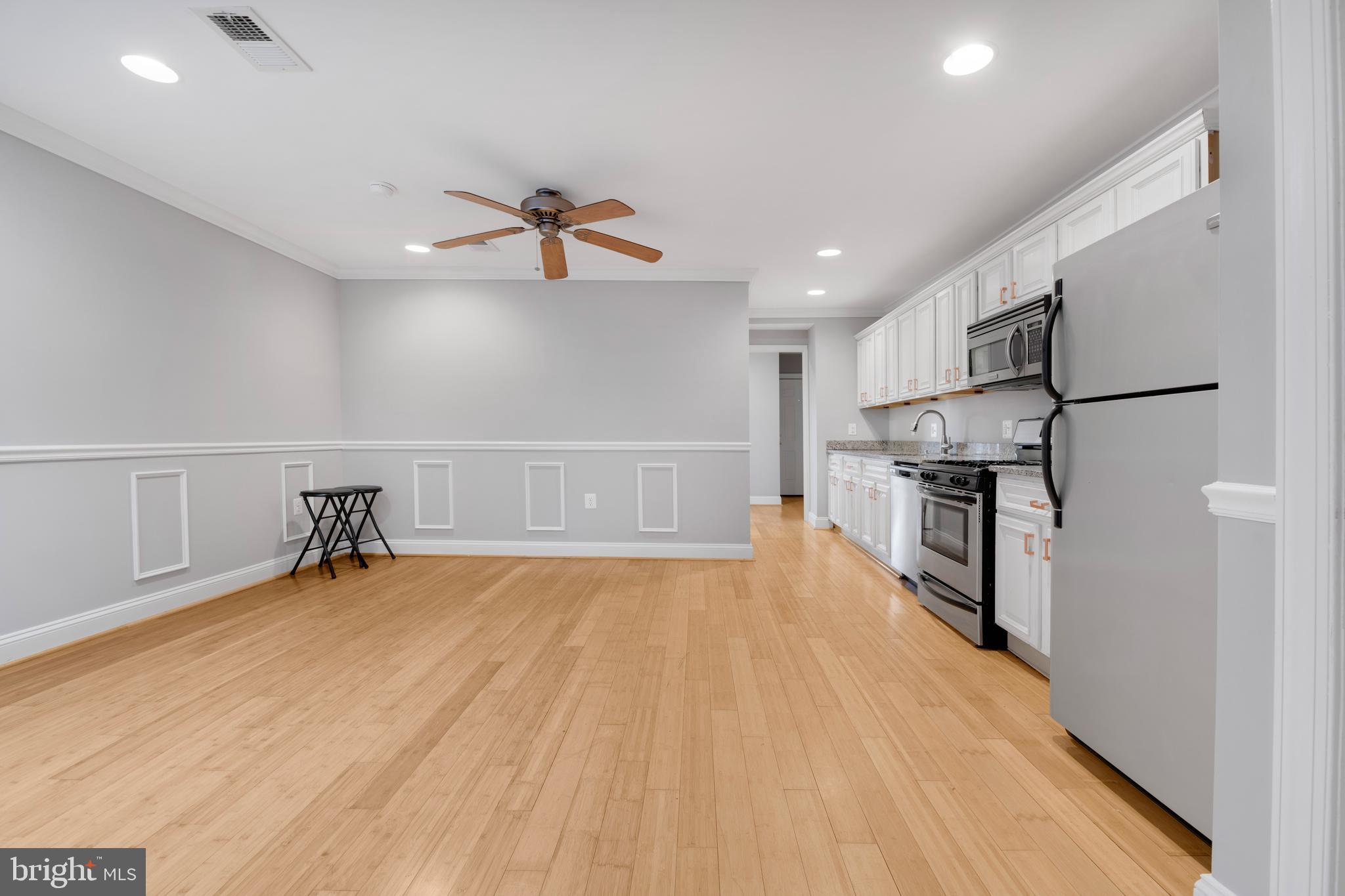 1917 Rosedale Street Northeast, Unit 3 Washington, DC 20002 - Photo 2 of 15 a view of empty room with wooden floor and fireplace