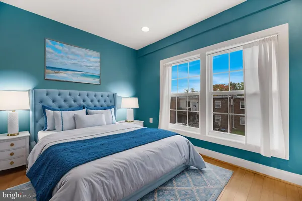 a bed sitting in a bedroom next to a window