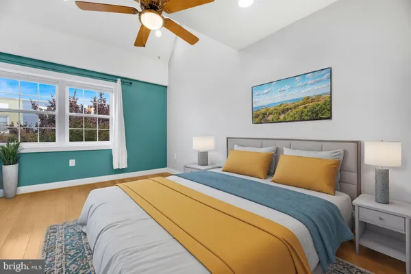 a bedroom with a bed and a painting on the wall