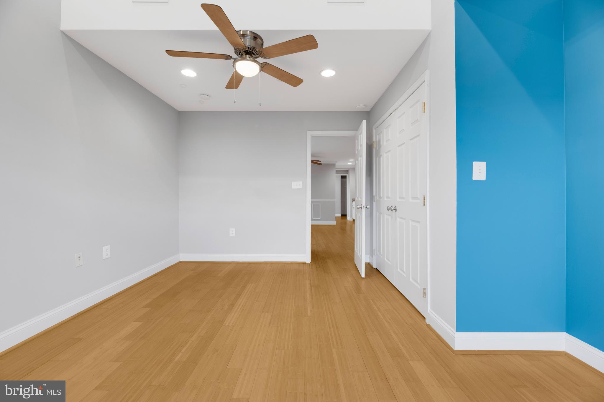 1917 Rosedale Street Northeast, Unit 3 Washington, DC 20002 - Photo 10 of 15 a view of a big room with wooden floor and a ceiling fan