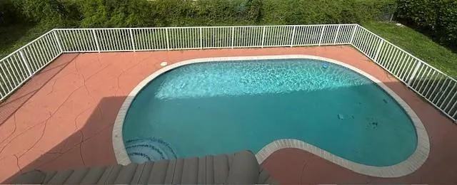 a view of a swimming pool with a balcony