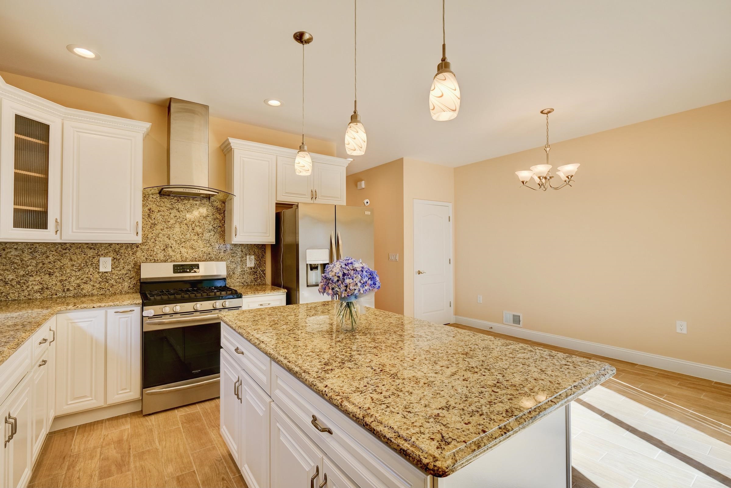 726 Chestnut Street, Unit B Secaucus, NJ 07094 - Photo 11 of 50 a kitchen with stainless steel appliances granite countertop a stove and cabinets