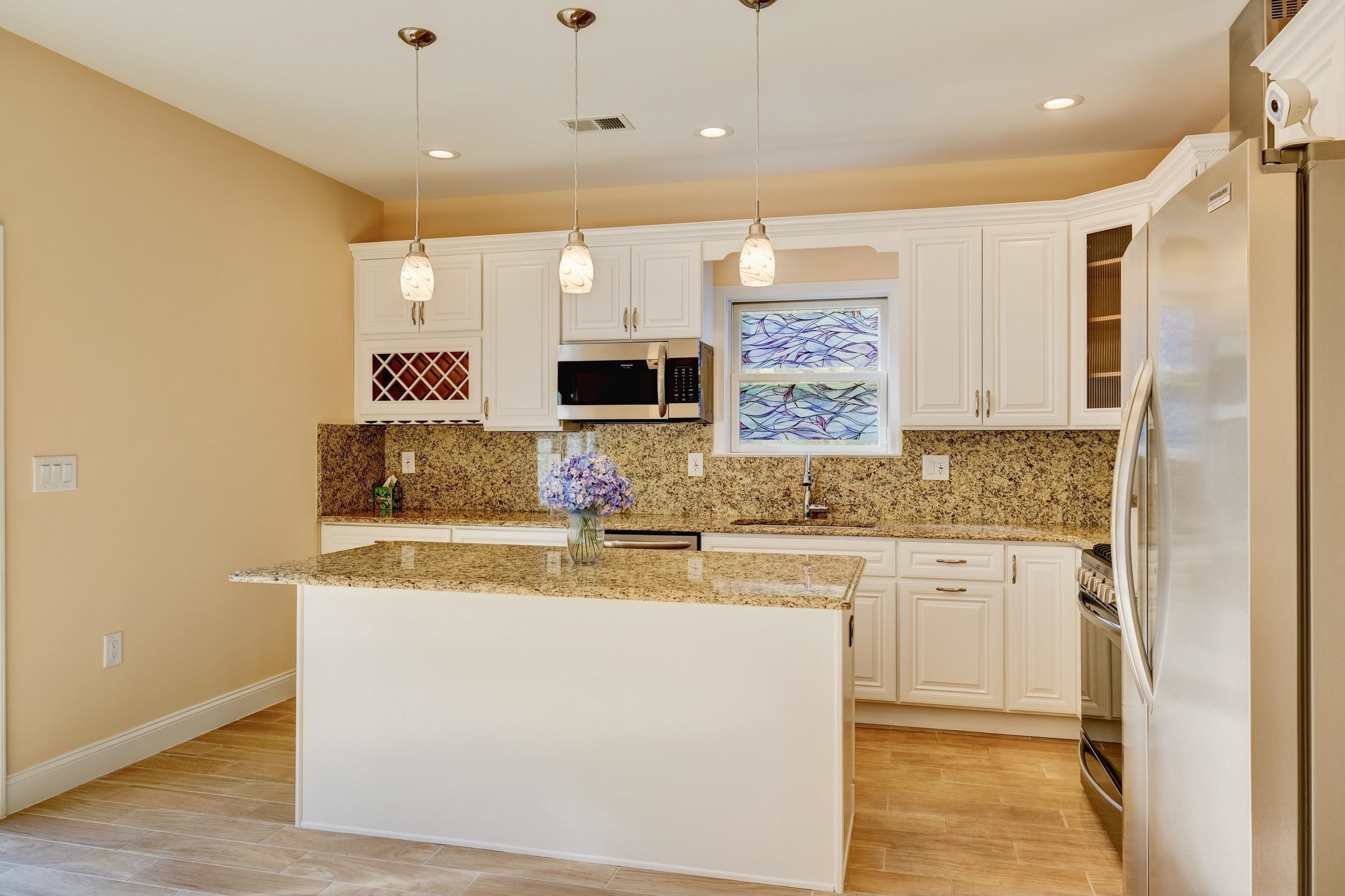 726 Chestnut Street, Unit B Secaucus, NJ 07094 - Photo 14 of 50 a kitchen with stainless steel appliances granite countertop a sink and a stove top oven