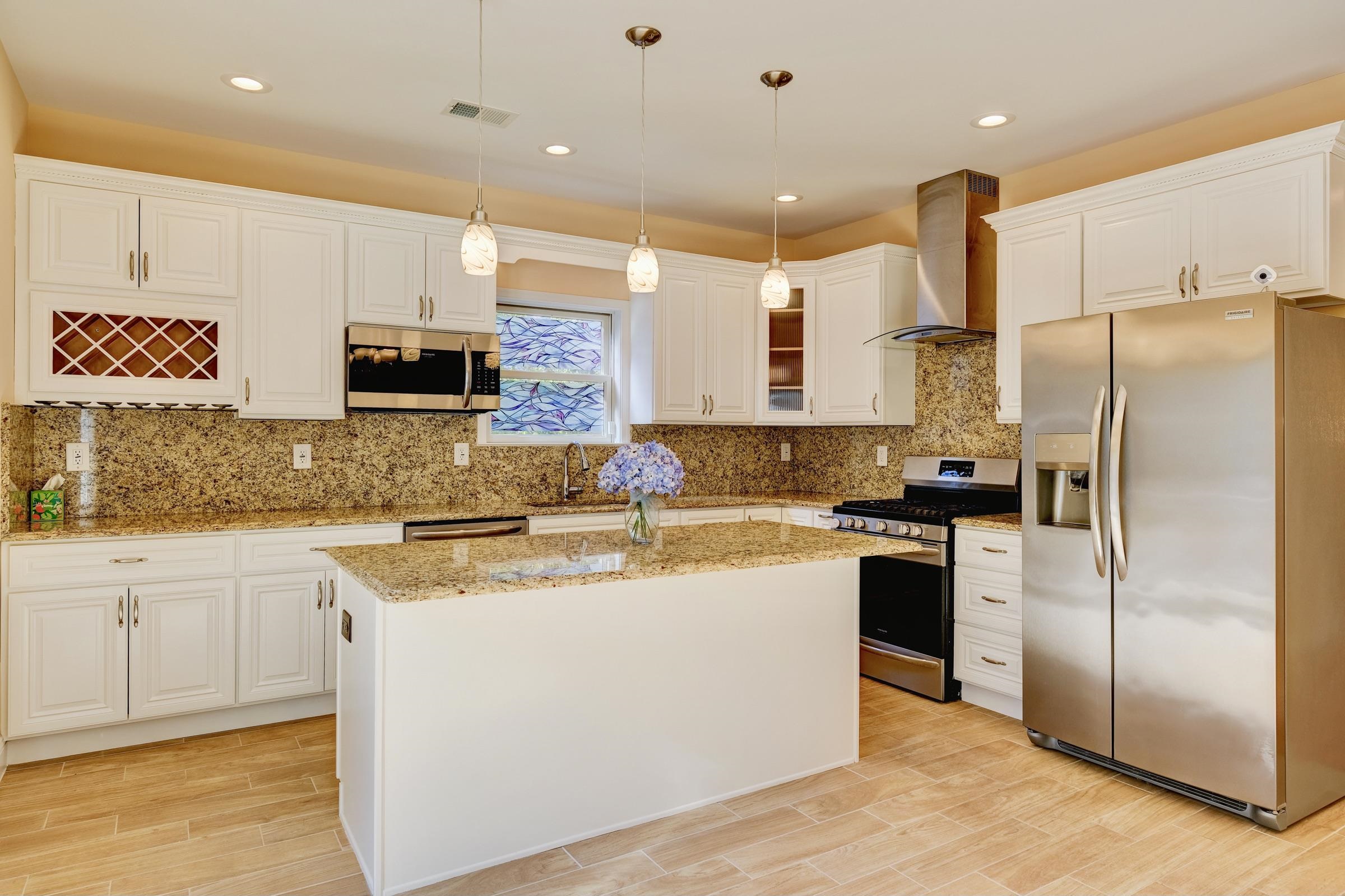 726 Chestnut Street, Unit B Secaucus, NJ 07094 - Photo 15 of 50 a kitchen with stainless steel appliances granite countertop a refrigerator a stove a sink and a microwave