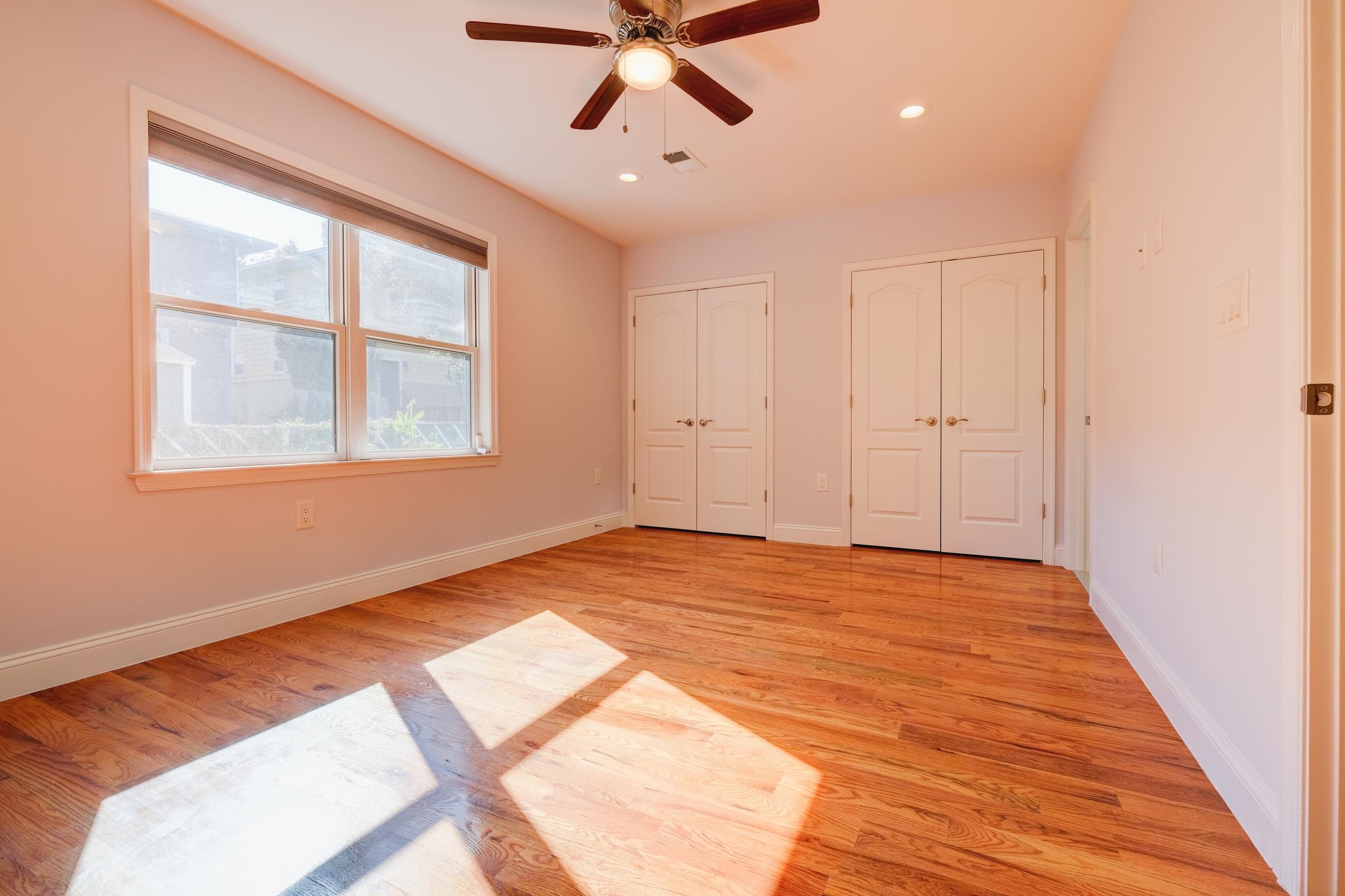 726 Chestnut Street, Unit B Secaucus, NJ 07094 - Photo 24 of 50 a view of an empty room with a window and wooden floor