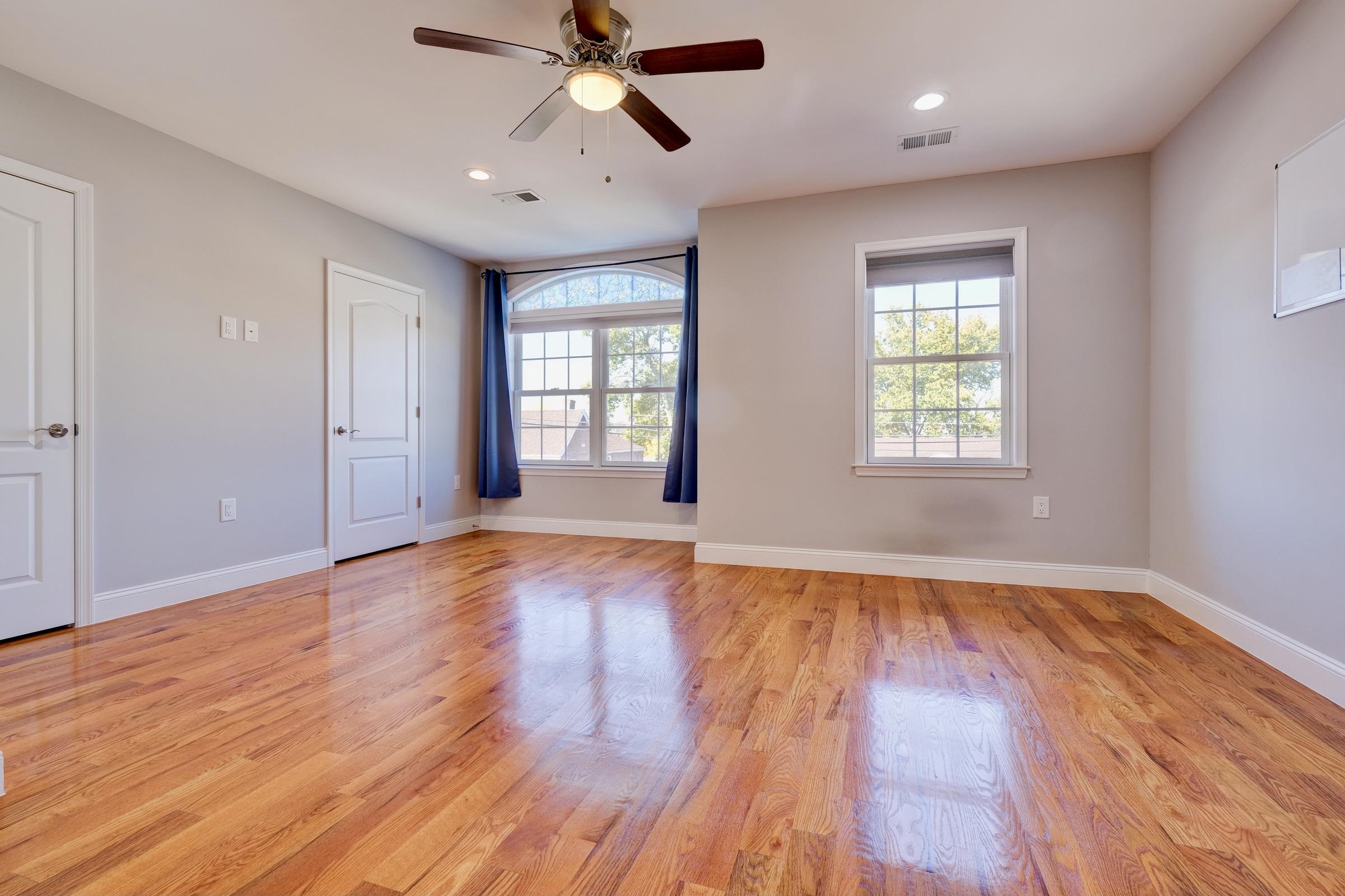 726 Chestnut Street, Unit B Secaucus, NJ 07094 - Photo 29 of 50 a view of empty room with wooden floor and fan