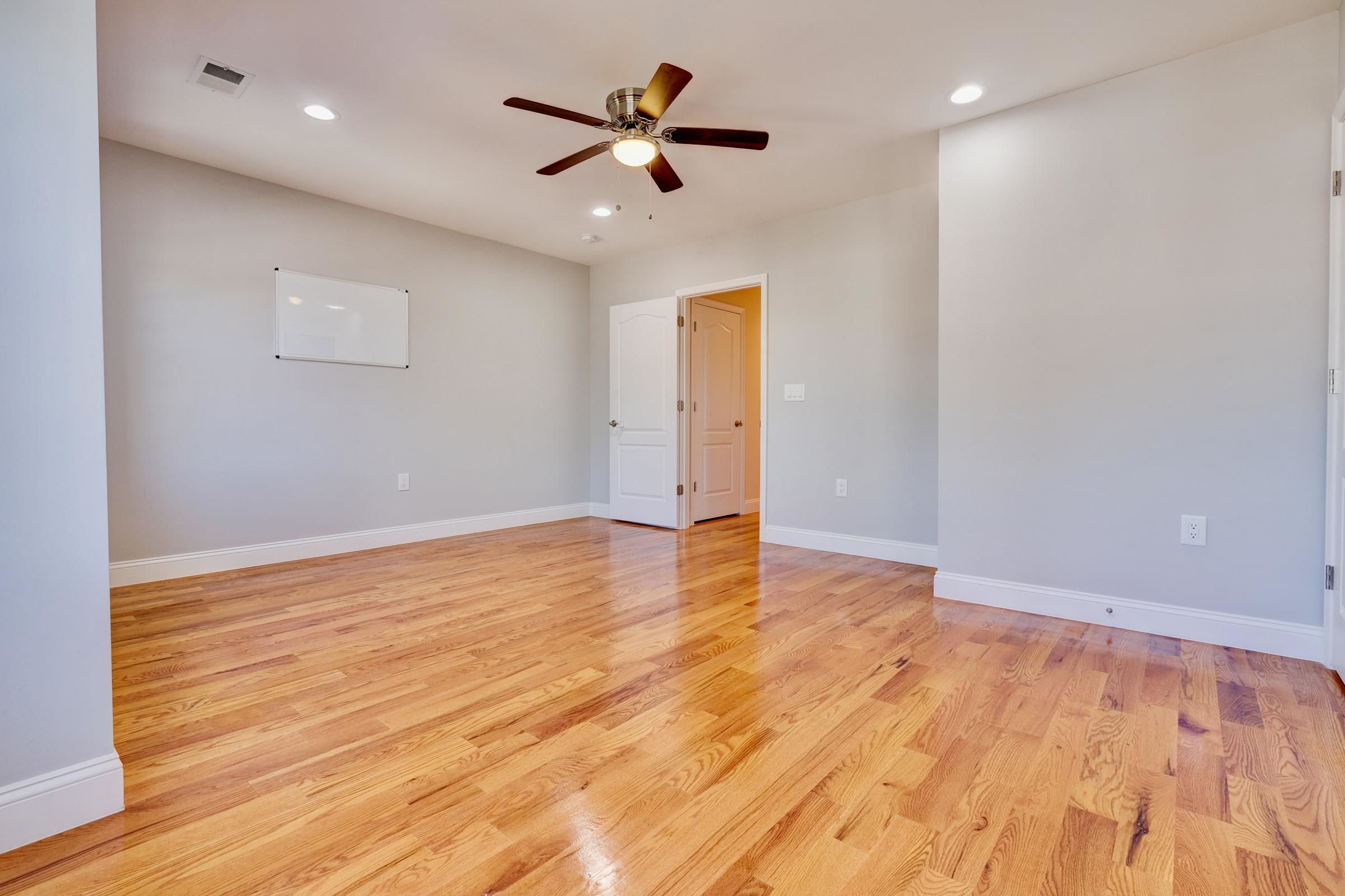 726 Chestnut Street, Unit B Secaucus, NJ 07094 - Photo 30 of 50 a view of a room with wooden floor and a ceiling fan