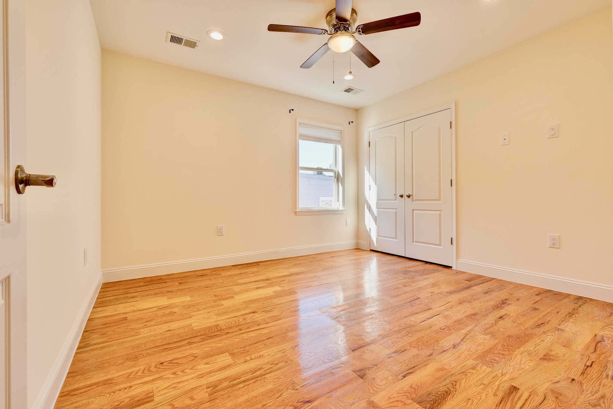 726 Chestnut Street, Unit B Secaucus, NJ 07094 - Photo 33 of 50 a view of an empty room with wooden floor and a ceiling fan