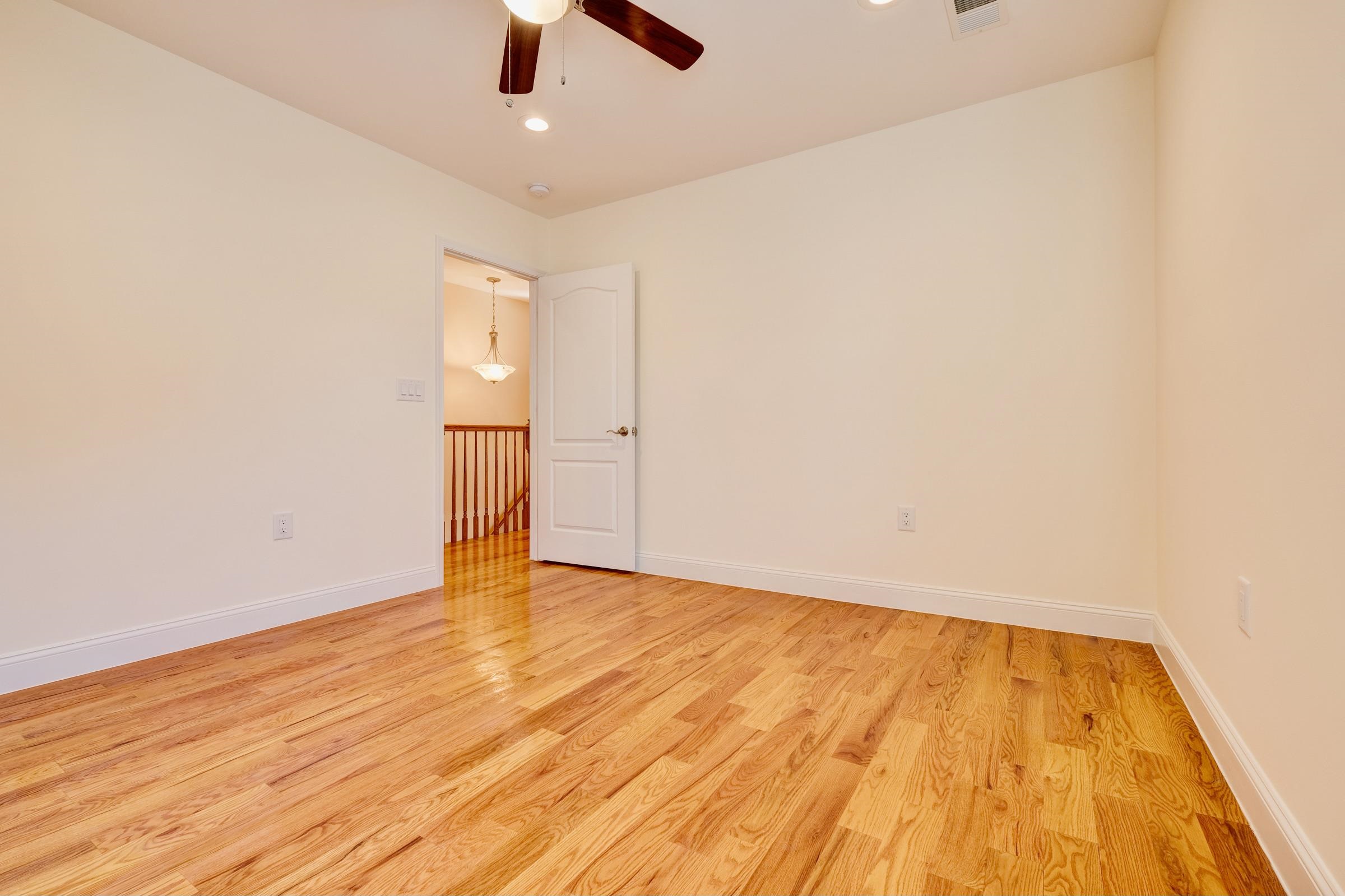 726 Chestnut Street, Unit B Secaucus, NJ 07094 - Photo 34 of 50 an empty room with wooden floor and windows