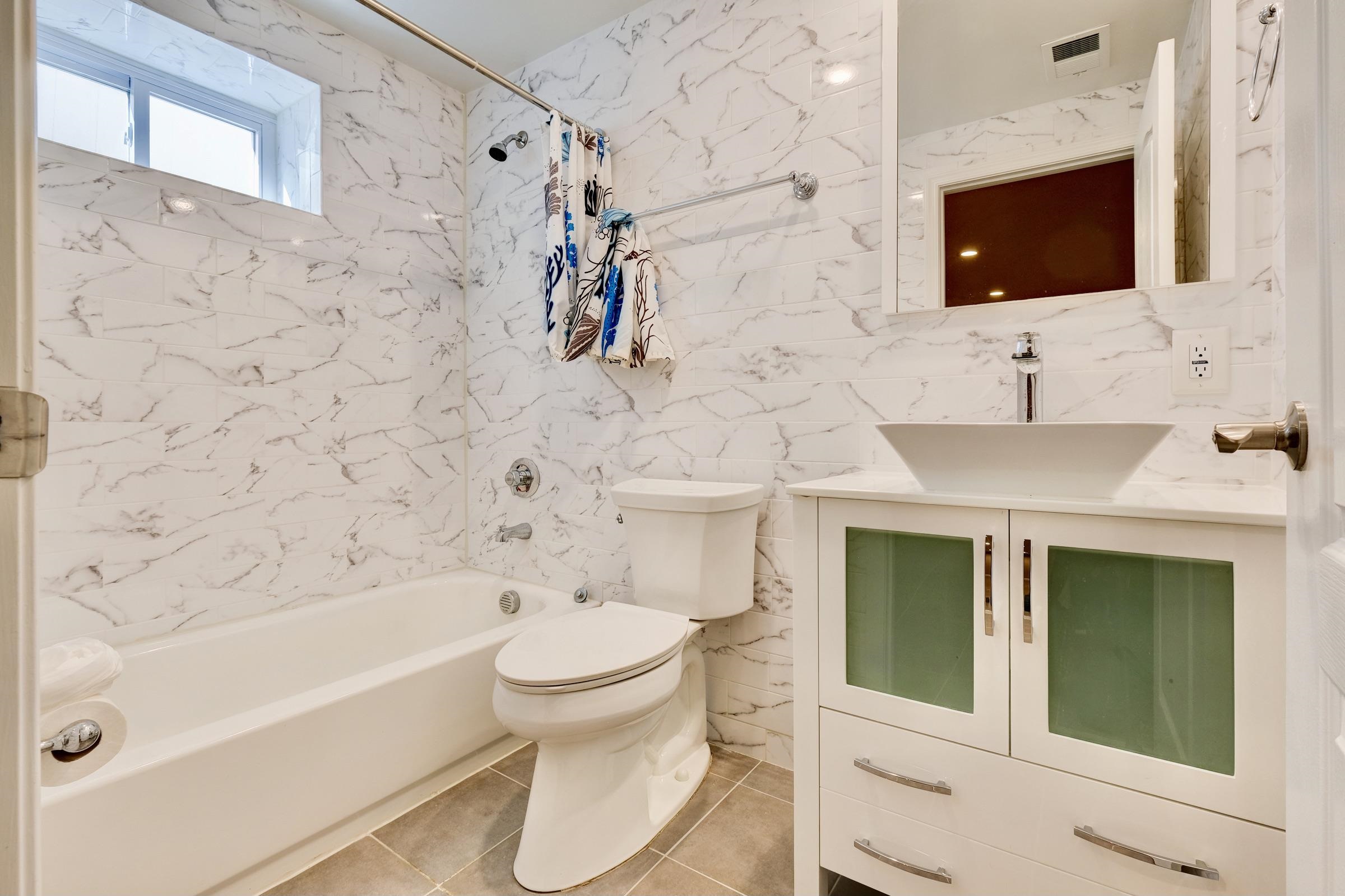 726 Chestnut Street, Unit B Secaucus, NJ 07094 - Photo 40 of 50 a bathroom with a toilet sink and mirror