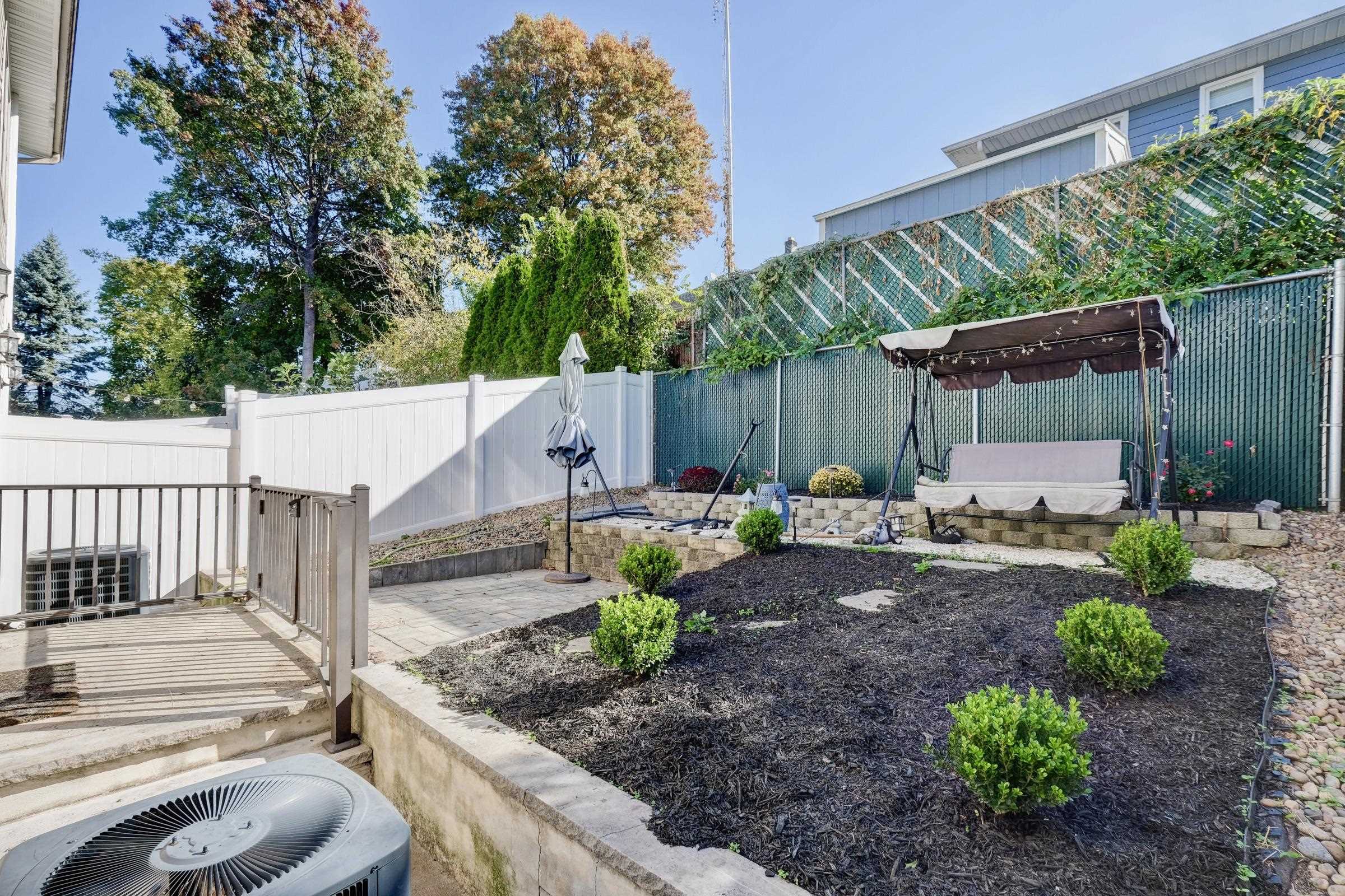 726 Chestnut Street, Unit B Secaucus, NJ 07094 - Photo 44 of 50 a view of a backyard with plants and a patio