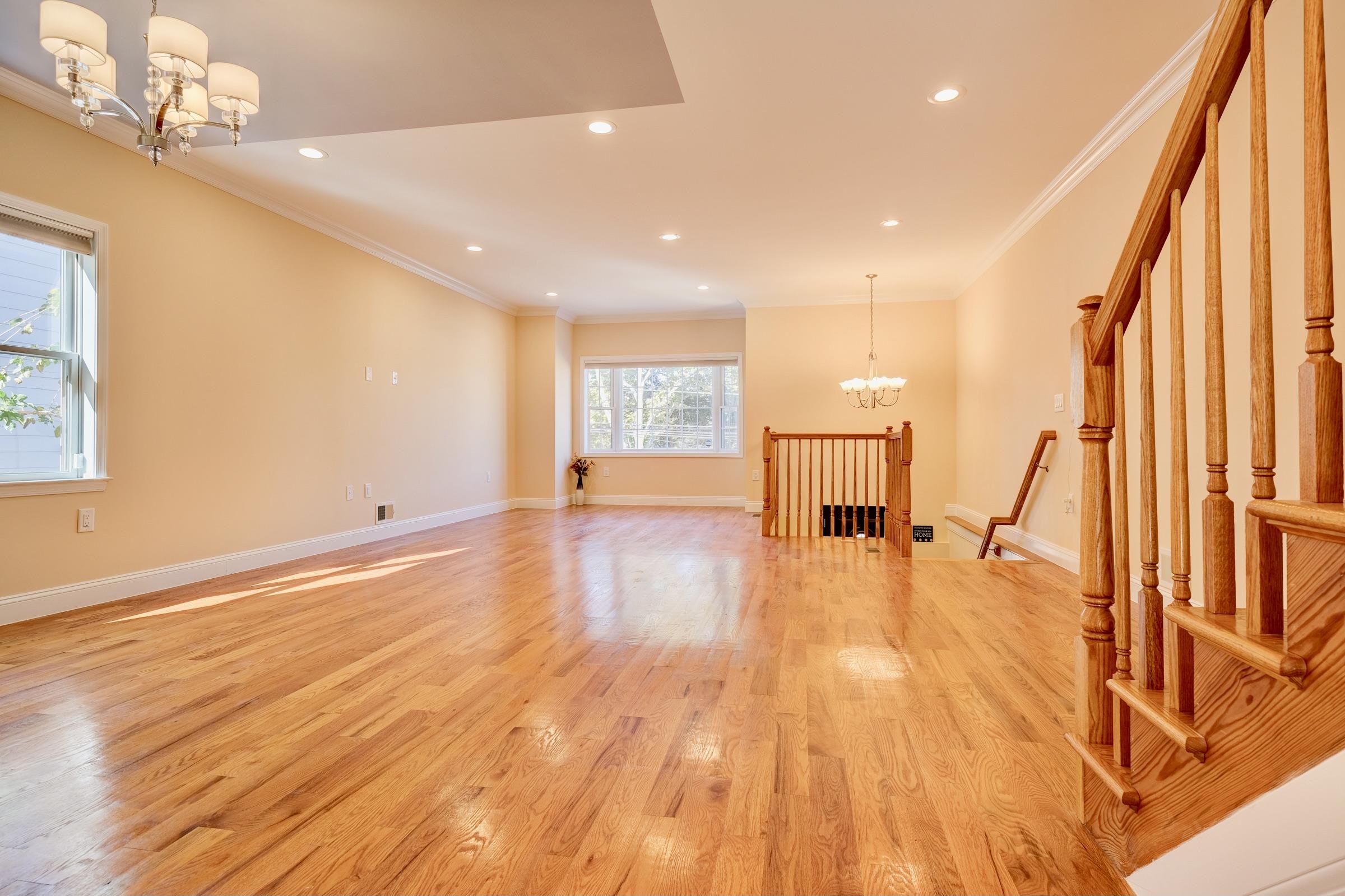 726 Chestnut Street, Unit B Secaucus, NJ 07094 - Photo 7 of 50 a view of an empty room with wooden floor and stairs