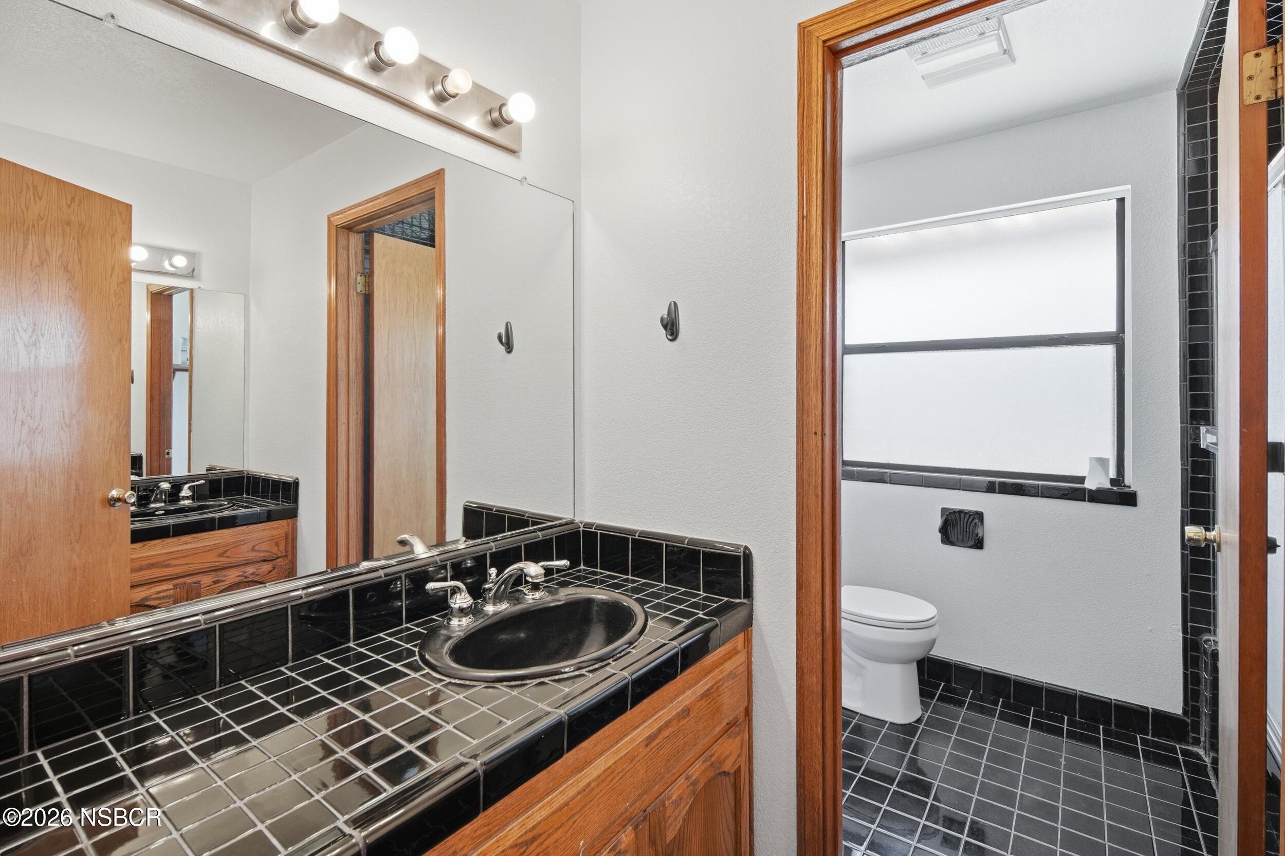 140 East Rice Ranch Road Santa Maria, CA 93455 - Photo 23 of 44 a bathroom with a sink a toilet and shower