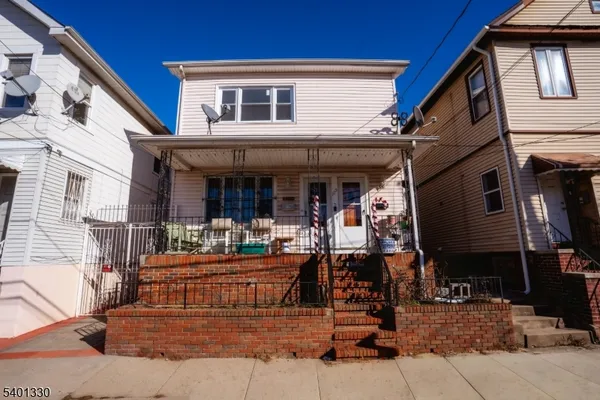 a view of a house with backyard porch and sitting area