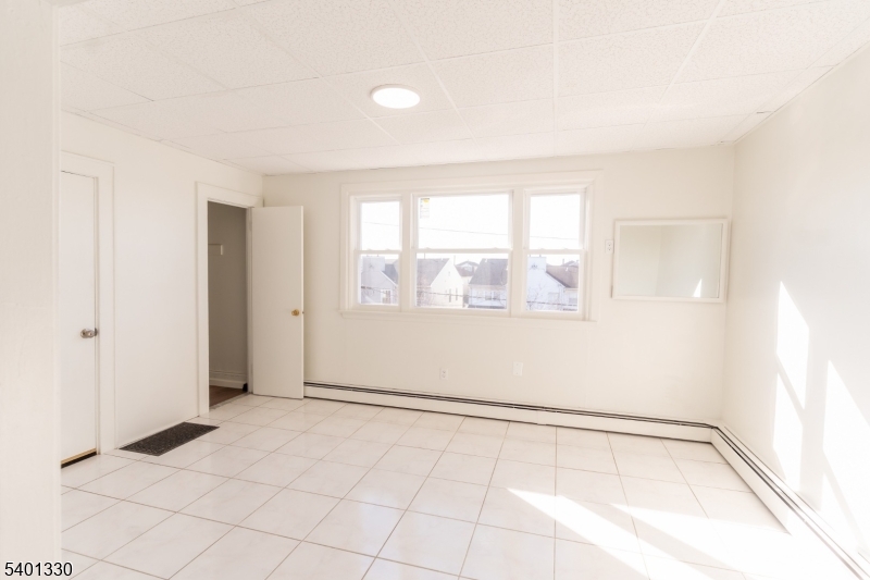 123 Clark Place Elizabeth Port, NJ 07206 - Photo 3 of 17 a view of an empty room with a window