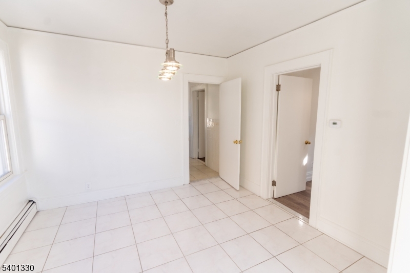 123 Clark Place Elizabeth Port, NJ 07206 - Photo 5 of 17 a view of an empty room and chandelier fan