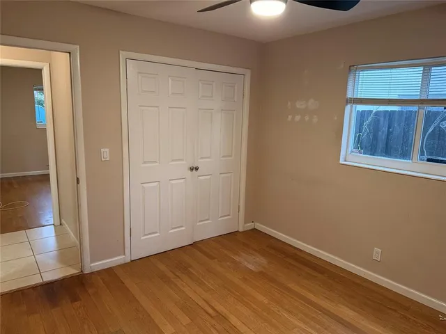 an empty room with a hardwood and wooden floor