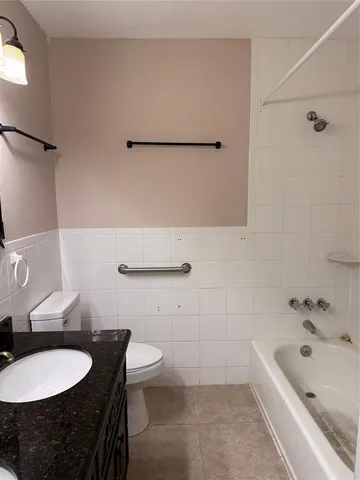 a bathroom with a sink a toilet and bathtub