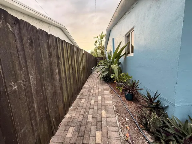a view of a pathway with a potted plants