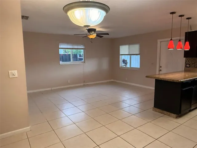 a view of a room with a cabinet and chandelier
