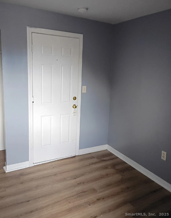 974 Iranistan Avenue, Unit 15 Bridgeport, CT 06604 - Photo 2 of 4 a view of an empty room with wooden floor