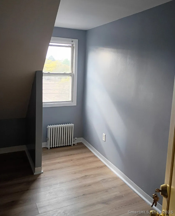 974 Iranistan Avenue, Unit 15 Bridgeport, CT 06604 - Photo 4 of 4 an empty room with wooden floor and a window