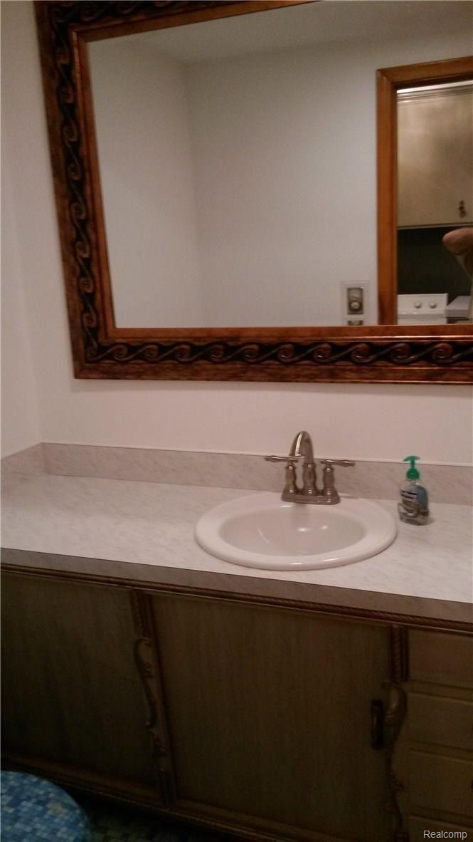 1195 Torpey Road Troy, MI 48083 - Photo 21 of 39 Vanity & Mirror in the Lav which is by the Laundry area.