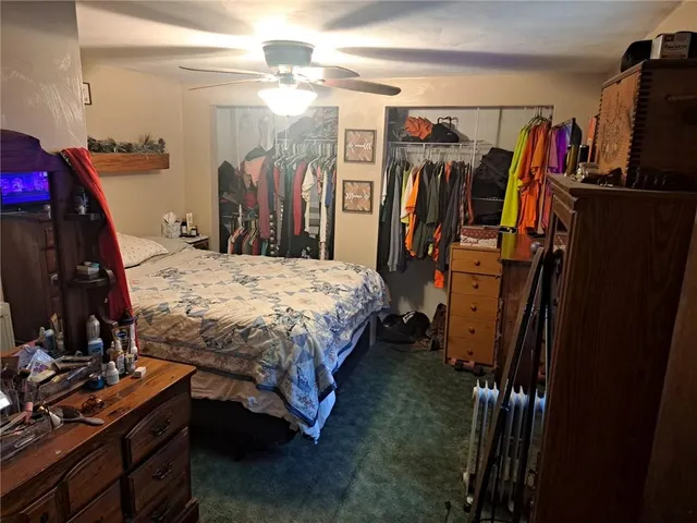 a bedroom with a bed closet and a mirror