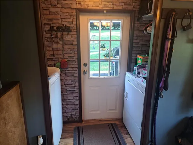a view of walk in closet with wooden floor