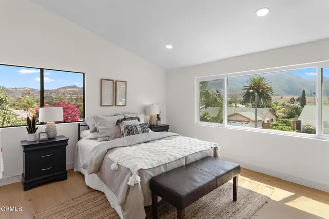 a bedroom with a bed and a large window