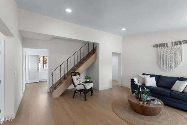a living room with furniture and stairs