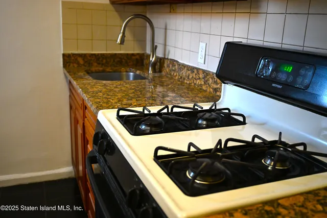a kitchen with a stove and a sink