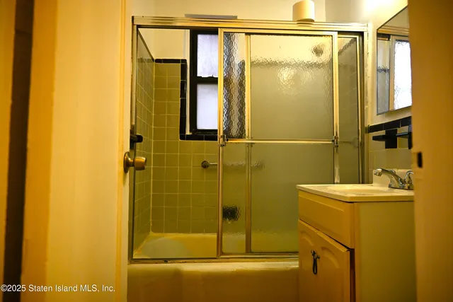 a bathroom with a shower and a sink