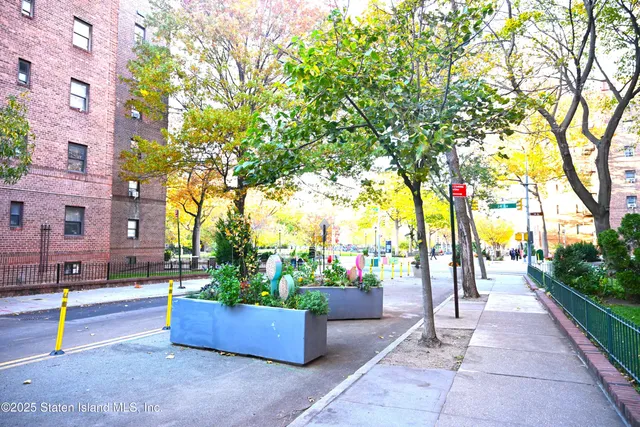 a sign board with buildings in the background