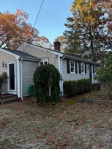 a view of a house with a yard and plants