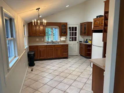 a kitchen with stainless steel appliances a refrigerator and a stove top oven