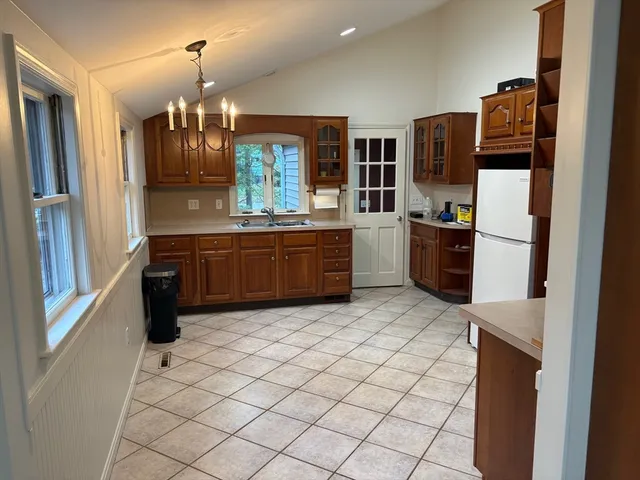 a kitchen with stainless steel appliances a refrigerator and a stove top oven