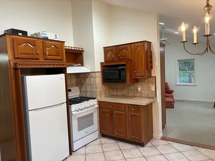a kitchen with stainless steel appliances granite countertop a refrigerator and a stove