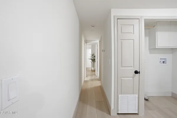 a view of a hallway with wooden floor